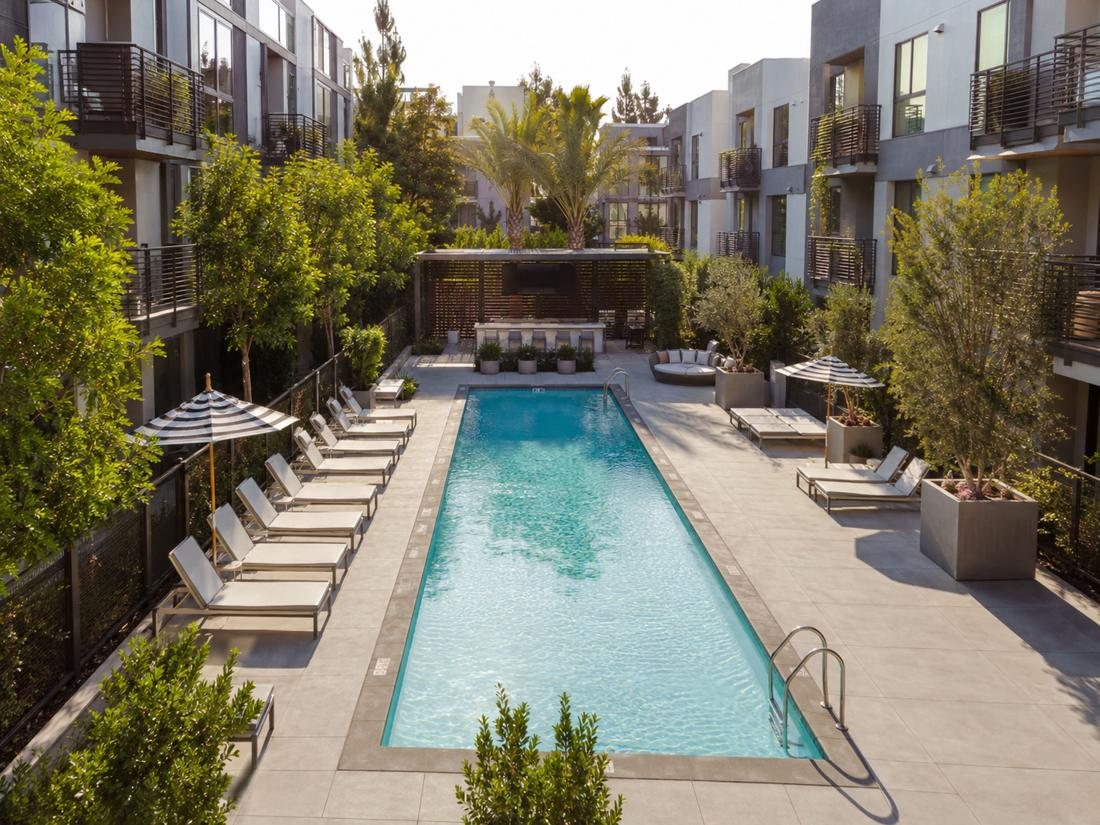 Apartment community courtyard pool with lounge chairs