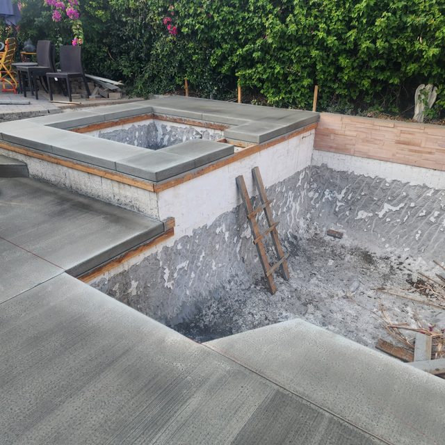 Pool and spa stripped to bare shell with new coping set