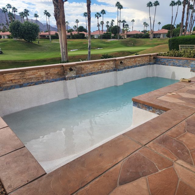 Freshly replastered golf course pool refilling